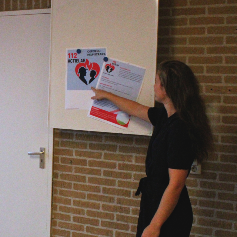 basisscholen Een vrouw wijst naar informatie op een muur.